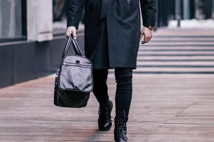 man carrying bag